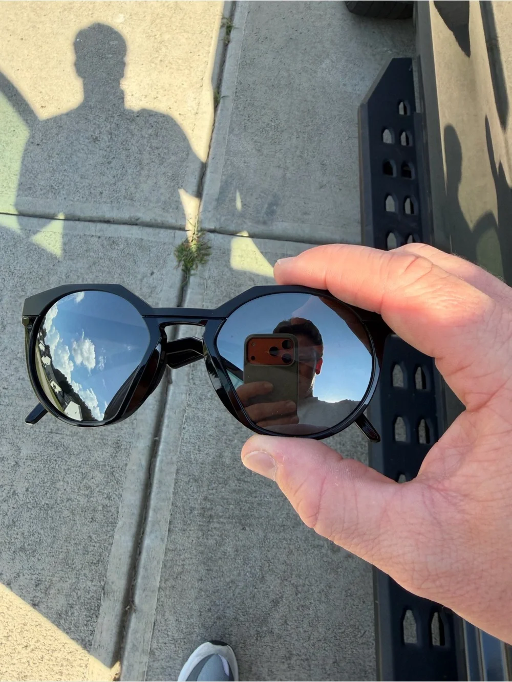 Oakley Men’s Black Round Frame Sunglasses with Silver Logo Accent